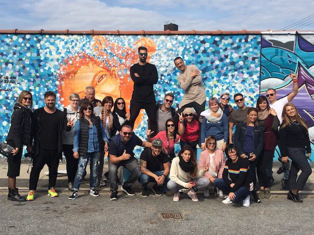 tour group in front of street art mural